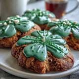 Festive shamrock-shaped sugar cookies decorated with vibrant green royal icing, perfect for St. Patrick's Day celebrations.