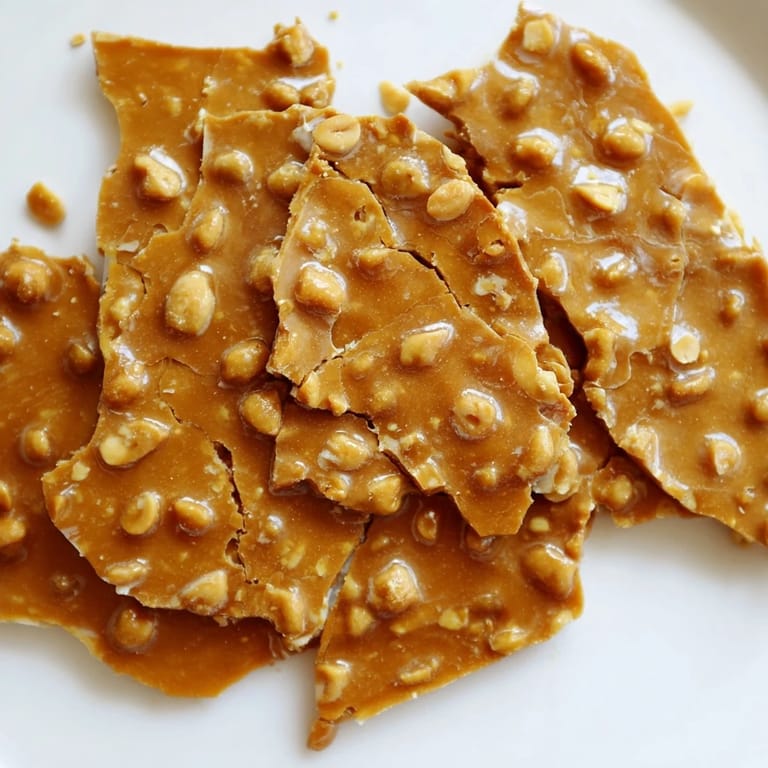 Perfect for gifting, this homemade peanut brittle shimmers with a glossy, buttery texture.