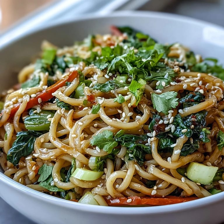 Close-up of a low-carb shirataki noodle bowl with bright vegetables, sesame seeds, and a savory tamari glaze.