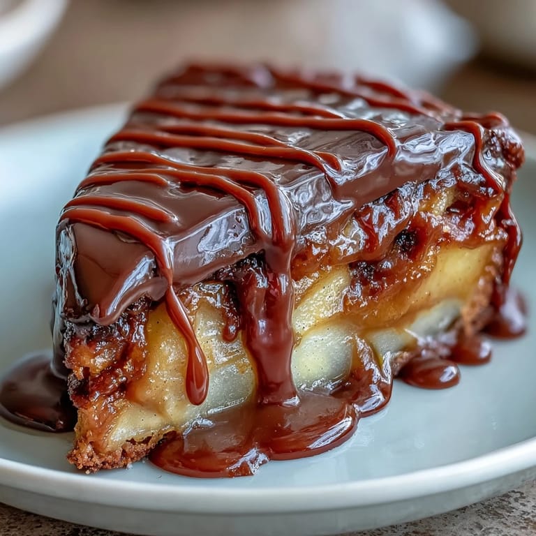 Tart apple slices covered in creamy caramel and topped with a glossy chocolate drizzle, garnished with chopped nuts or sprinkles.