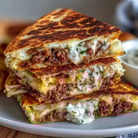 Crispy quesadillas stuffed with savory shepherds pie filling and creamy mashed potatoes, served golden and melty.