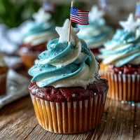 Festive Star-Spangled Banner Cupcakes with edible flags, a sweet treat.